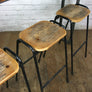 A Set of Three Rustic Bar Height Stools